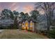 Beautiful home with a three-car garage, manicured landscaping, and a grand entrance at sunset at 275 Tynebrae Pl, Roswell, GA 30075