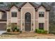 Close up of home's front entrance with beautiful stone walkway and decorative wreath at 275 Tynebrae Pl, Roswell, GA 30075