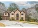 Stately two-story home with a symmetrical facade and a meticulously landscaped front yard at 275 Tynebrae Pl, Roswell, GA 30075