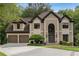 Stately two-story home with a manicured lawn and a three-car garage at 275 Tynebrae Pl, Roswell, GA 30075