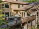 Elevated deck provides ample outdoor living space to this home, featuring multiple seating areas and lush, wooded backyard at 275 Tynebrae Pl, Roswell, GA 30075