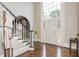 Elegant foyer with hardwood floors, a staircase, and a large window offering natural light at 275 Tynebrae Pl, Roswell, GA 30075