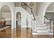 Elegant foyer with staircase, hardwood floors, and arched doorways at 275 Tynebrae Pl, Roswell, GA 30075