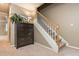 Hallway features a staircase, a dark wood dresser with decorations, carpet, and neutral walls at 275 Tynebrae Pl, Roswell, GA 30075