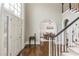Hallway leading to formal dining area featuring hardwood floors and high ceilings at 275 Tynebrae Pl, Roswell, GA 30075