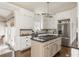 Bright kitchen features white cabinets, stainless steel appliances, granite countertops, and a functional center island at 275 Tynebrae Pl, Roswell, GA 30075