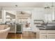 Open concept kitchen boasts granite countertops, stainless steel appliances, a wine fridge, and backyard view at 275 Tynebrae Pl, Roswell, GA 30075