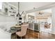 Open concept kitchen and dining area features granite counters, wine fridge, breakfast nook, and backyard access at 275 Tynebrae Pl, Roswell, GA 30075
