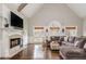 Comfortable living room featuring a fireplace, vaulted ceilings, hardwood floors, and ample seating at 275 Tynebrae Pl, Roswell, GA 30075
