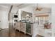 Open-concept living room and kitchen area with vaulted ceilings, fireplace, large windows, and a wine fridge at 275 Tynebrae Pl, Roswell, GA 30075