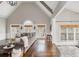 Spacious living room with hardwood floors, large windows, vaulted ceilings, and access to the outdoor deck at 275 Tynebrae Pl, Roswell, GA 30075