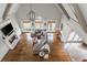 Aerial view of the living room with vaulted ceilings, fireplace, hardwood floors, and large windows overlooking the yard at 275 Tynebrae Pl, Roswell, GA 30075