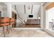 Open-concept living room features a staircase, modern lighting, and a seamless transition to the kitchen area at 275 Tynebrae Pl, Roswell, GA 30075