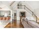 Bright open space featuring a living room, staircase, vaulted ceilings, and seamless access to the kitchen at 275 Tynebrae Pl, Roswell, GA 30075