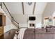Bright living room with vaulted ceilings, fireplace, television, and staircase to the upper level at 275 Tynebrae Pl, Roswell, GA 30075