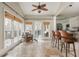 Inviting living space with travertine flooring, large windows, opens to deck, and connects to a bar area with seating at 275 Tynebrae Pl, Roswell, GA 30075