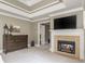 Main bedroom with a fireplace, a television, trey ceilings, and lots of natural light at 275 Tynebrae Pl, Roswell, GA 30075