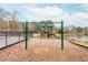 Community playground featuring swings, slides and climbing structures on a mulch base near a pond at 275 Tynebrae Pl, Roswell, GA 30075