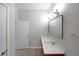 Bright bathroom with a large mirror over a vanity and a linen closet behind the door at 5300 Peachtree Rd. # 3107, Chamblee, GA 30341
