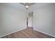 Bedroom with wood-look floors, neutral walls, and a glimpse into the adjacent kitchen at 5300 Peachtree Rd. # 3107, Chamblee, GA 30341