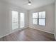 Bedroom with a balcony door and window allowing for plenty of natural light and wood-look floors at 5300 Peachtree Rd. # 3107, Chamblee, GA 30341