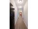 Inviting hallway featuring wood floors and a glimpse into the modern kitchen at 5300 Peachtree Rd. # 3107, Chamblee, GA 30341