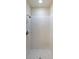 Shower stall with modern white marble-look tiles, mosaic floor, and sleek fixtures at 5300 Peachtree Rd. # 3107, Chamblee, GA 30341