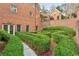 Manicured backyard with sculpted bushes and landscaped garden with brick and concrete features at 540 Saint James Pl, Marietta, GA 30064