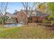 Spacious backyard featuring a well-manicured lawn, mature trees, and a stone patio at 540 Saint James Pl, Marietta, GA 30064