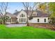 Spacious backyard featuring a well-manicured lawn, mature trees, and a stone patio at 540 Saint James Pl, Marietta, GA 30064