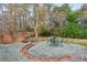 Outdoor patio area surrounded by a lush, landscaped backyard and mature trees at 540 Saint James Pl, Marietta, GA 30064