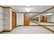 Spacious basement area with wall mirrors, white metal shelving, and trim detail throughout at 540 Saint James Pl, Marietta, GA 30064