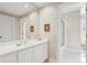 Bright bathroom showcasing white cabinets, marble countertops, and a large mirror, plus walk-in shower at 540 Saint James Pl, Marietta, GA 30064