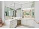 Elegant bathroom featuring mirrors, a tiled countertop with vanity, and white cabinets at 540 Saint James Pl, Marietta, GA 30064