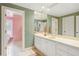 Bright bathroom featuring striped wallpaper, a long vanity, and tiled flooring at 540 Saint James Pl, Marietta, GA 30064