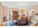 Formal dining room with wood floors, chandelier, antique furnishings and pink patterned walls at 540 Saint James Pl, Marietta, GA 30064