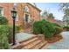 Brick steps lead to a grand entryway, complemented by lush landscaping and a vintage street lamp at 540 Saint James Pl, Marietta, GA 30064