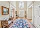 Elegant foyer with soaring ceilings, wood floors, large rug, and a striking chandelier at 540 Saint James Pl, Marietta, GA 30064