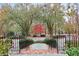 Inviting front entrance with landscaped garden, iron fencing and brick walkway at 540 Saint James Pl, Marietta, GA 30064