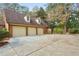 Three-car garage with brick siding and dormer windows offering both functionality and timeless appeal at 540 Saint James Pl, Marietta, GA 30064