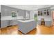 Open-concept kitchen features an island with cooktop, grey cabinetry, and stainless steel appliances at 540 Saint James Pl, Marietta, GA 30064