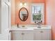 Powder room with sink, vanity, mirror, window, patterned wallpaper, and overhead lighting at 540 Saint James Pl, Marietta, GA 30064