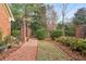 Brick walkway with landscaped gardens, brick columns and iron fencing leading to the property at 540 Saint James Pl, Marietta, GA 30064