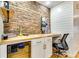 Stylish home office with a built-in desk, brick accent wall, and sleek modern décor at 920 Memorial Se Dr # 35, Atlanta, GA 30316