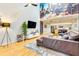 Cozy living area with hardwood floors, large mural, modern TV, and a comfortable leather sofa at 920 Memorial Se Dr # 35, Atlanta, GA 30316