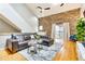 Inviting living space with exposed brick, hardwood floors, plush leather sofa, and bright natural light at 920 Memorial Se Dr # 35, Atlanta, GA 30316