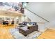 Open-concept living and dining area with hardwood floors, a leather sofa, and a wall-sized mural at 920 Memorial Se Dr # 35, Atlanta, GA 30316