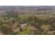 Aerial view of the home on the wooded acreage at 1074 Whooping Creek Rd, Carrollton, GA 30116