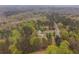 Aerial view of the home on the wooded acreage at 1074 Whooping Creek Rd, Carrollton, GA 30116