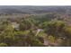 Aerial view of the home on the wooded acreage at 1074 Whooping Creek Rd, Carrollton, GA 30116
